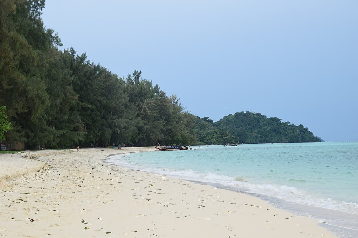 White sand and clear shallow water on the east beach of Koh Kradan
