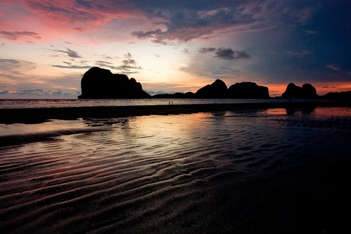 Sunset over Pak Meng beach with a limestone island silhouetted offshore